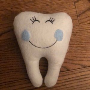 Tooth fairy pillow with tooth pocket in back